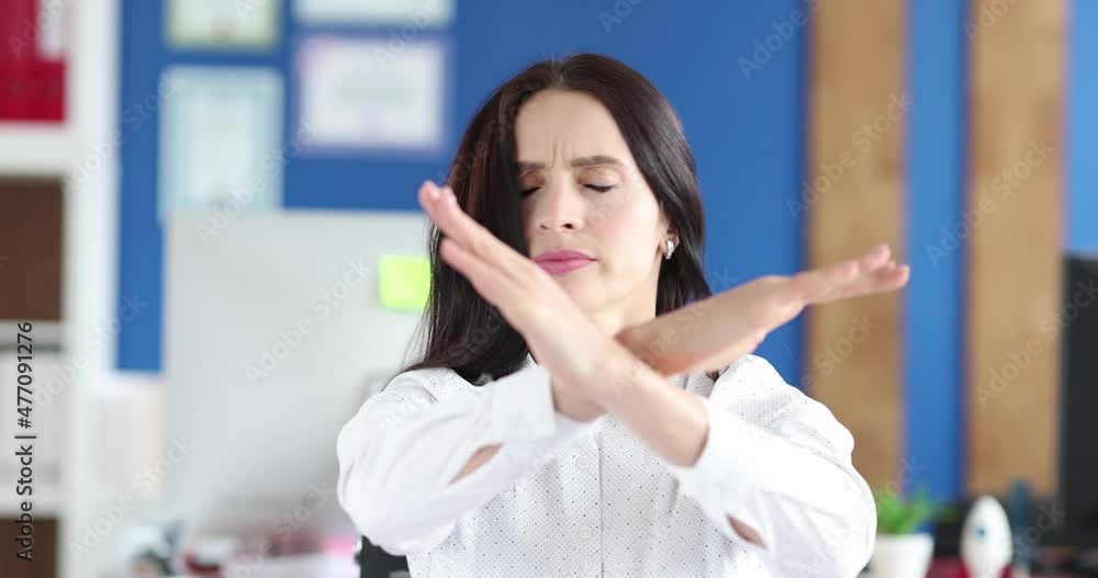 Portrait of young businesswoman makes denial gesture and shakes her head Portrait of young businesswoman makes denial gesture and shakes her head