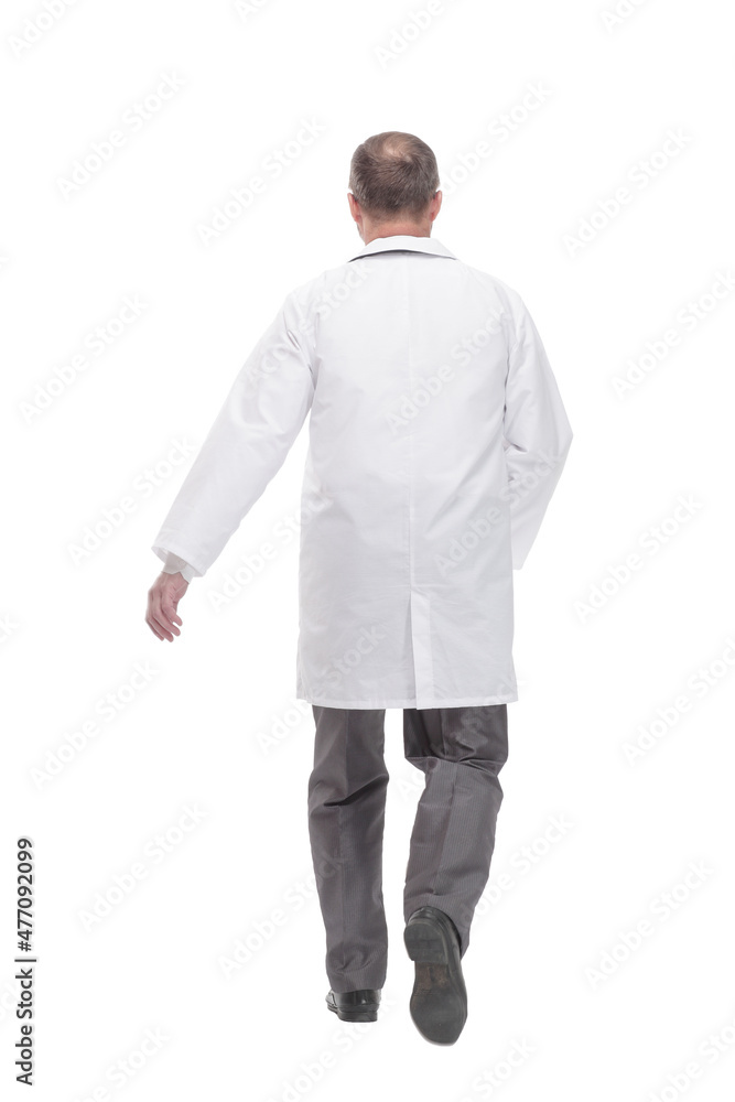 Mature male doctor striding forward. isolated on a white background.