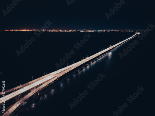 Night top view of the bridge illuminated by road lights
