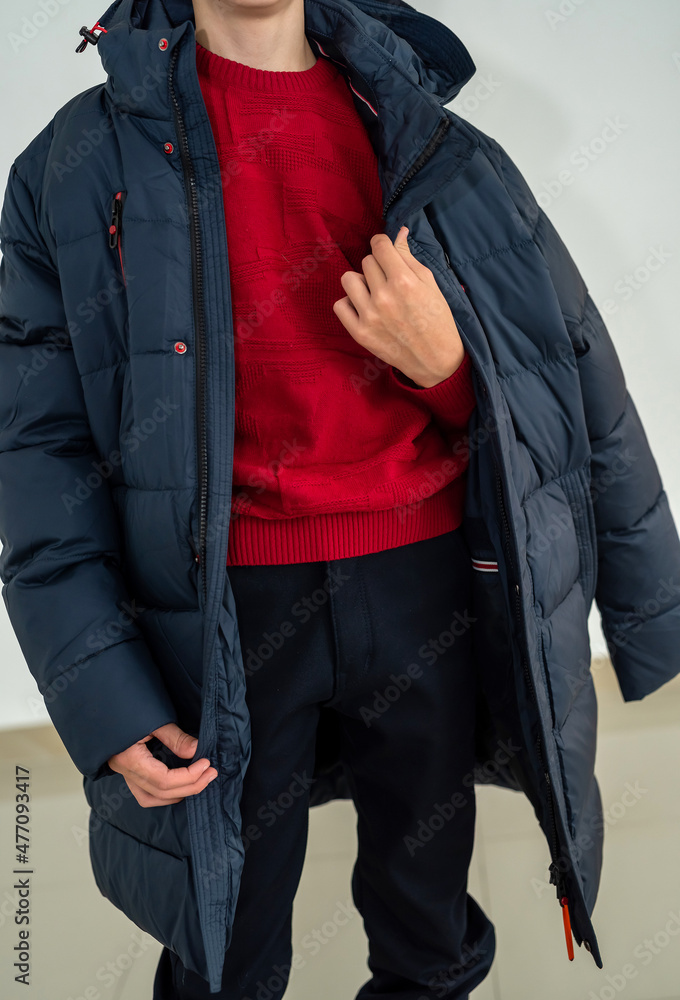 a young guy tries on winter images to choose the most comfortable. a young guy tries on winter images to choose the most comfortable.