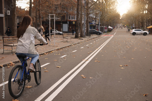 Wallpaper Mural Woman riding bicycle on lane in city Torontodigital.ca