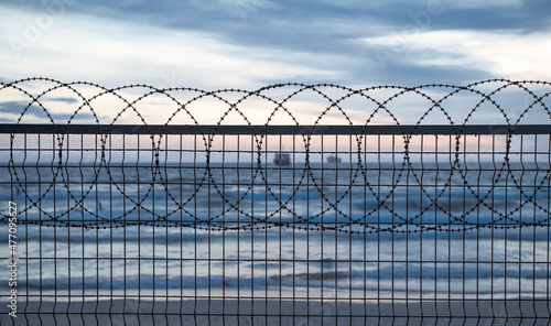 Fence barbed wire and ship on the background © Serhat