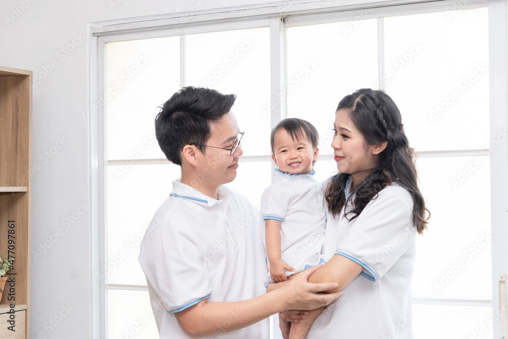 Asian happy family, father and mother kissing their baby at home. Asian happy family, father and mother kissing their baby at home.
