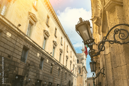 Lecce, Puglia, Italy. August 2021. View of one of the streets of the historic center with a characteristic vintage lantern lamp post. Beautiful summer day.