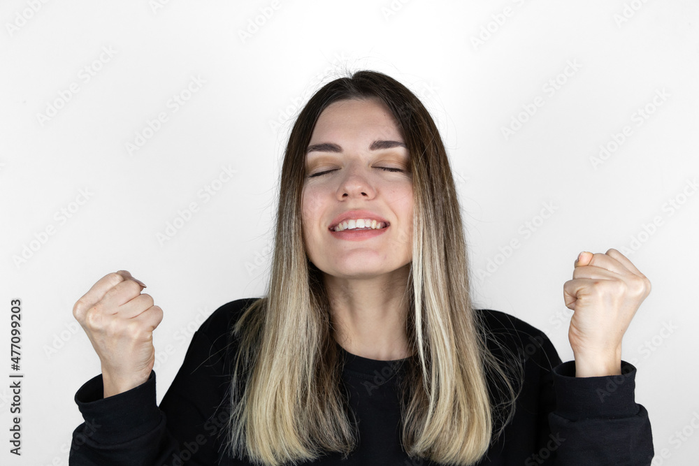 The girl has both hands at her side. Overly happy. Closed eyes. She got good news. Something she wanted has come true. She looks like she won the lottery. The girl has both hands at her side. Overly happy. Closed eyes. She got good news. Something she wanted has come true. She looks like she won the lottery.