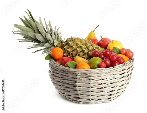 Wicker basket with different fresh fruits isolated on white