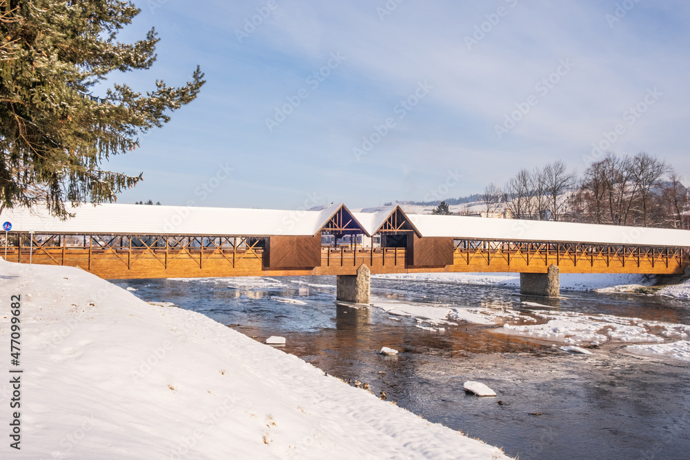 Colonnade Bridge of Dolný Kubín, which leads over the Orava River and connects the old part of the town with the town district of Veľký Bysterec. Wooden landmark, Northern Slovakia, winter time