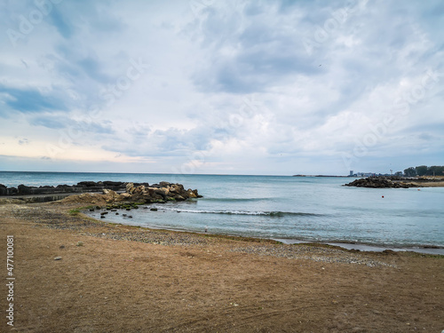 Fototapeta Naklejka Na Ścianę i Meble -  Sea shore with blue water, rocks and mistic summer sky