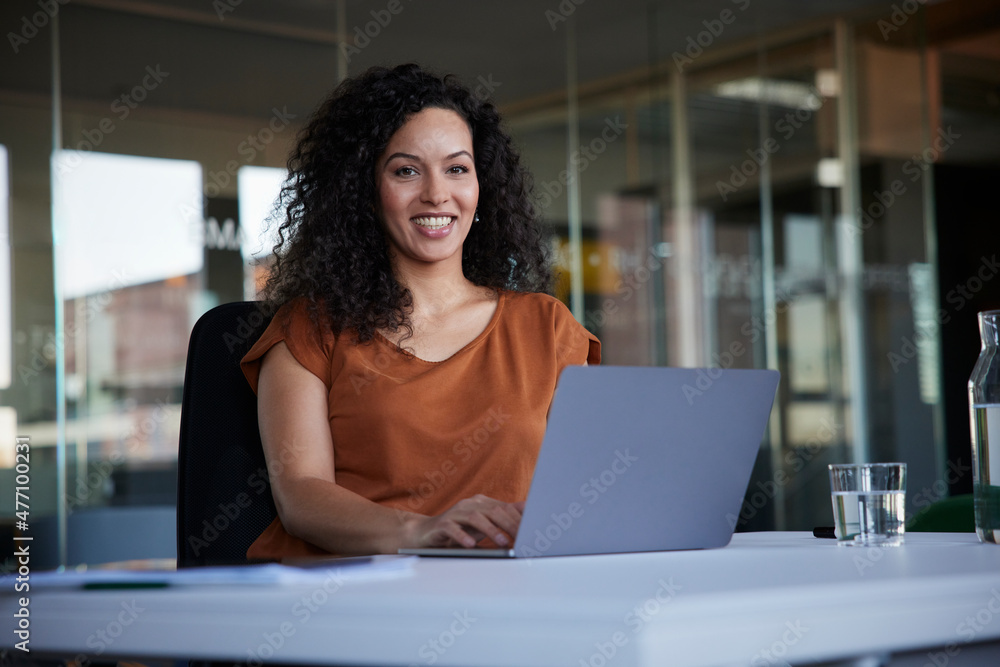Happy businesswoman with laptop on desk at workplace Happy businesswoman with laptop on desk at workplace