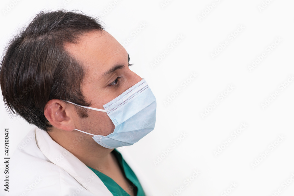 Male doctor wearing a mask on a light background