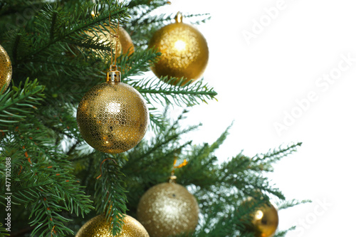 Christmas tree with golden baubles on white background, closeup