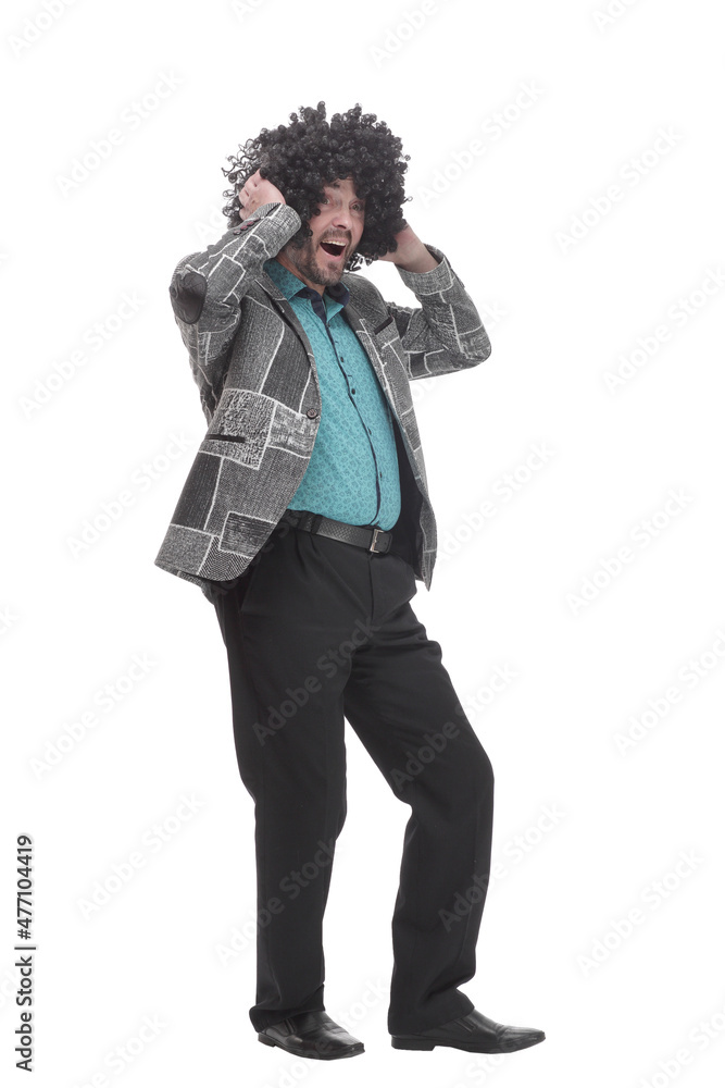 in full growth. cheerful man in a curly wig. in full growth. cheerful man in a curly wig.