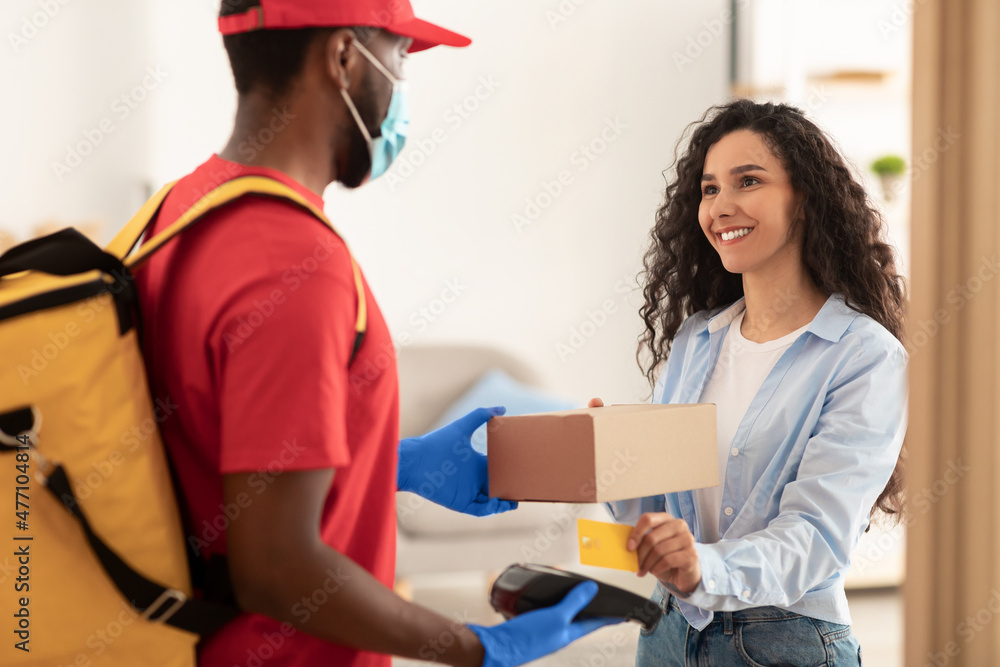 Black man holding POS machine lady paying with debit card Black man holding POS machine lady paying with debit card