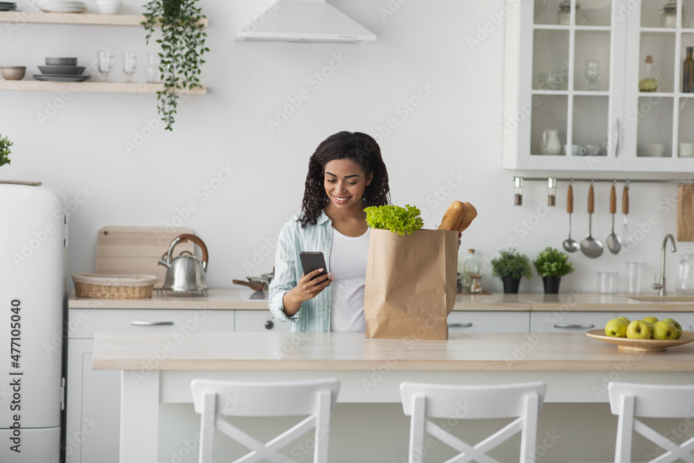Young woman home with heavy grocery bag