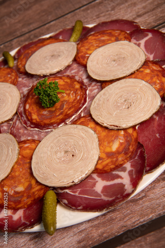 Food tray with delicious salami, pieces of sliced ham, sausage, Deli meats, Pickles, Hight quality photo