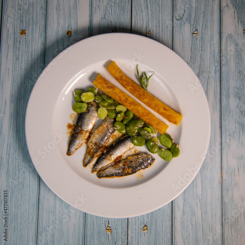 RECIPE OF SARDINE FILLETS MARINATED WITH CHILI, POLENTA WITH BEANS, SEEFOOD. High quality photo