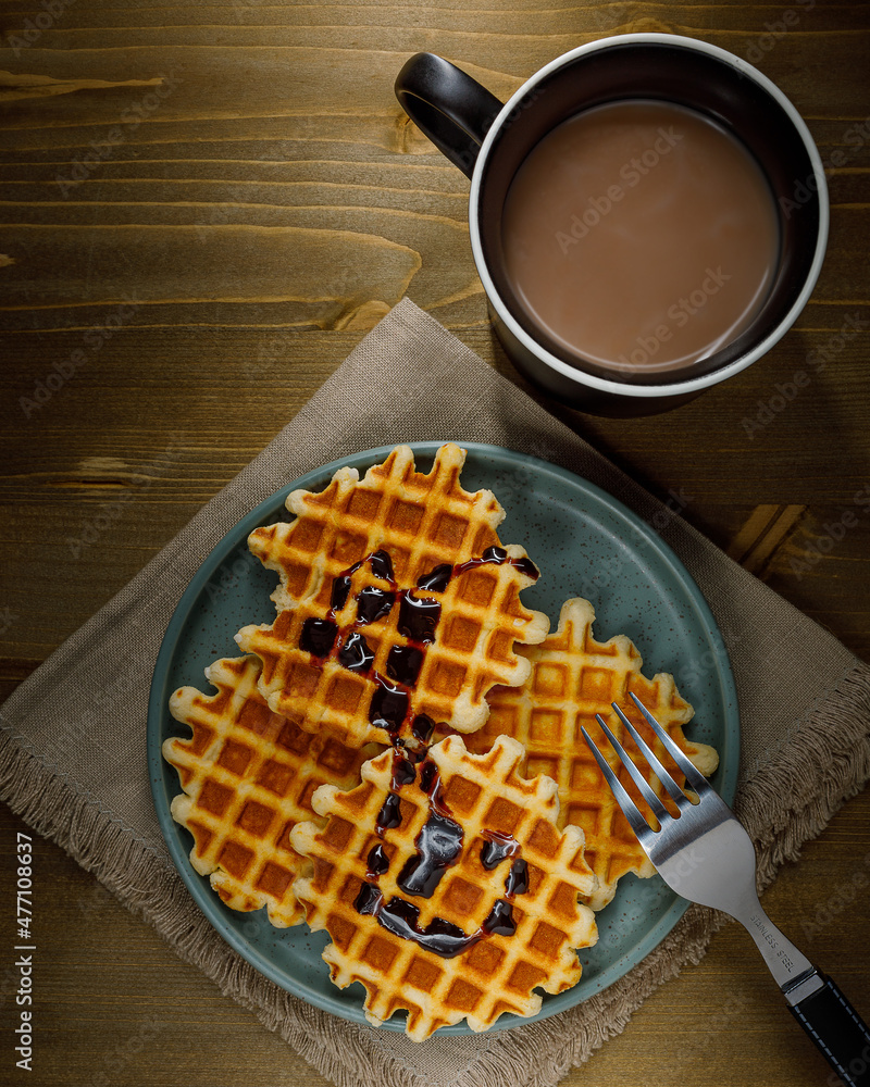 Homemade Belgium waffles served on a plate. Selective focus. Homemade Belgium waffles served on a plate. Selective focus.