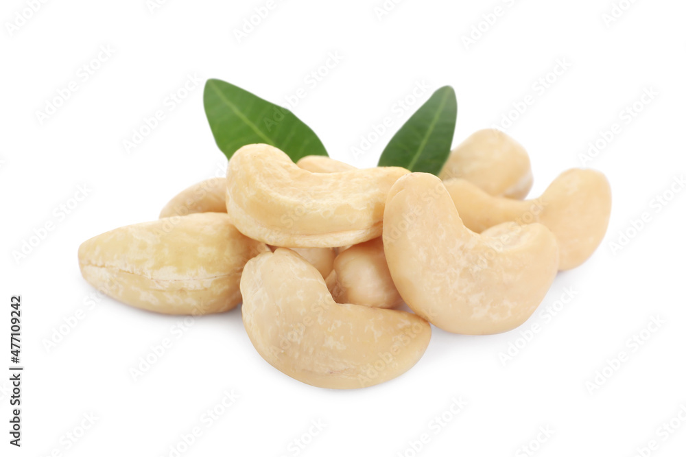 Pile of tasty organic cashew nuts and green leaves isolated on white Pile of tasty organic cashew nuts and green leaves isolated on white