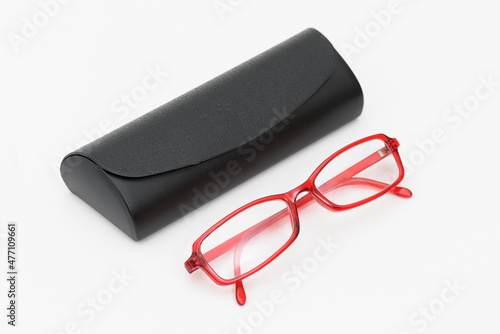 Red eyeglass and box on the white background.