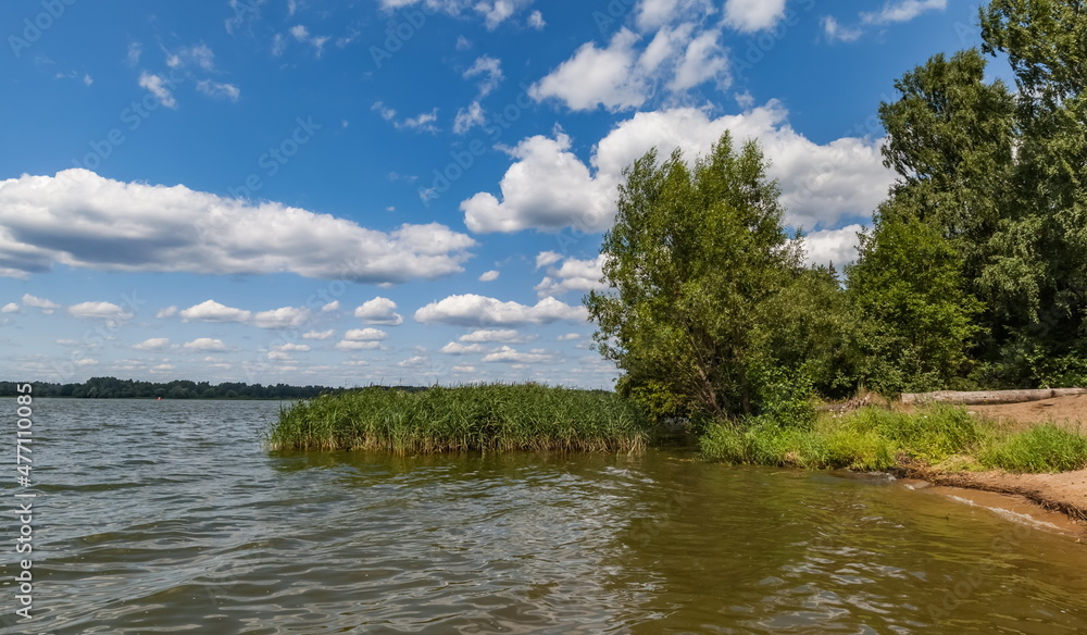 Summer landscape with river, ferry, trees and sky with clouds Summer landscape with river, ferry, trees and sky with clouds