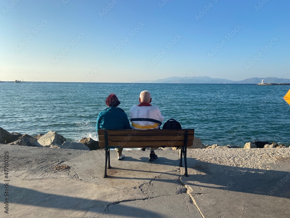 senior couple sitting on a bench