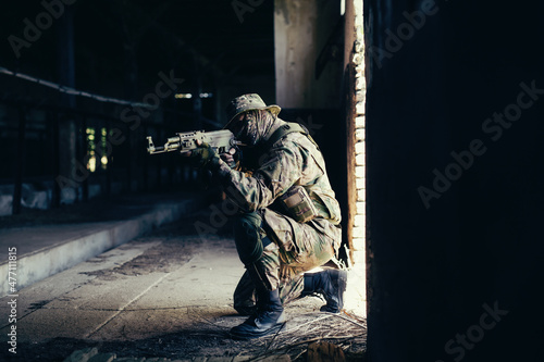 Fotografija Airsoft solder on battlefield. Airsoft soldier with a rifle.