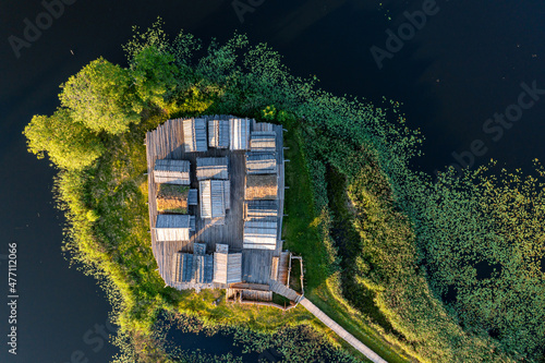 view from above of ancient wooden settlement on river island, recontruction of ancient architecture photo