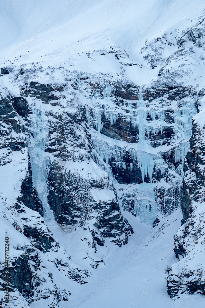 beautiful frozen waterfalls in winter in the alps, the hohe tauern national park in austria, at a cold winter day