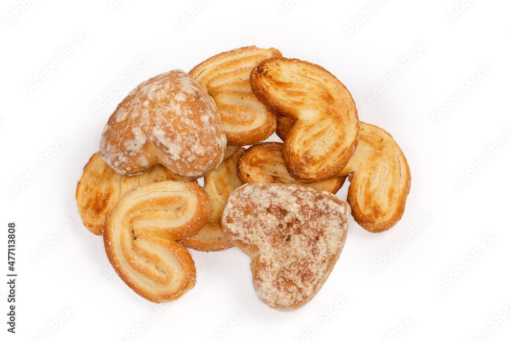 Flat puff pastry cookies and glazed gingerbreads on white background