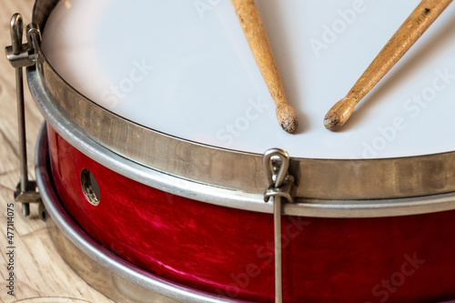 Pioneer red snare drum and wooden drumsticks.