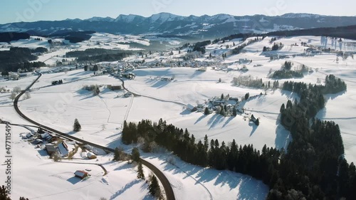 Aerial drone panoramic footage of the Alps mountain.  Snowy hills and tree tops in the Bavarian Alps in winter in Germany, close to Austria. Beatiful background with mountains, field and forest. 