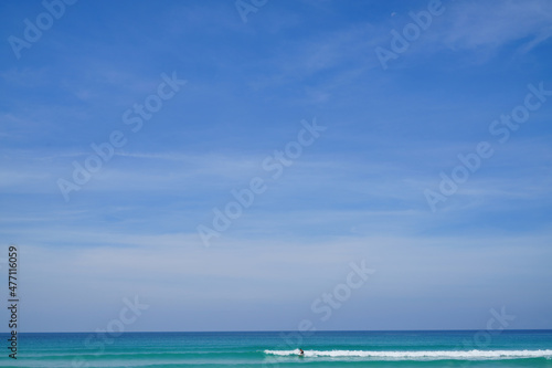 Surfer, Kata Noi Beach, Andaman Sea with blue sky Phuket, Thailand including copy space