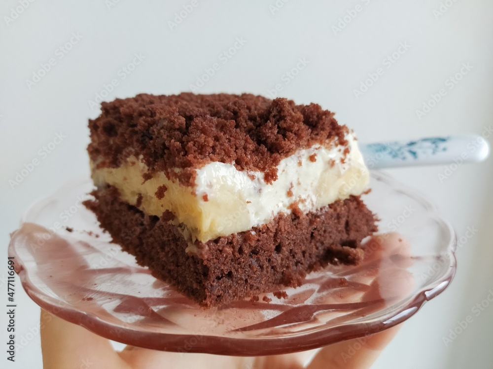 Cream piece of cake with icing and banana Cream piece of cake with icing and banana