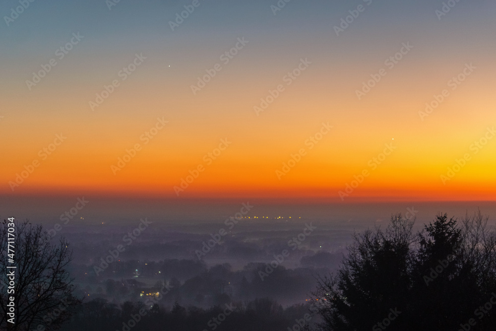 Fototapeta premium Conjunction of the Planets Venus and Jupiter at sunset over foggy landscape, Munsterland, Germany
