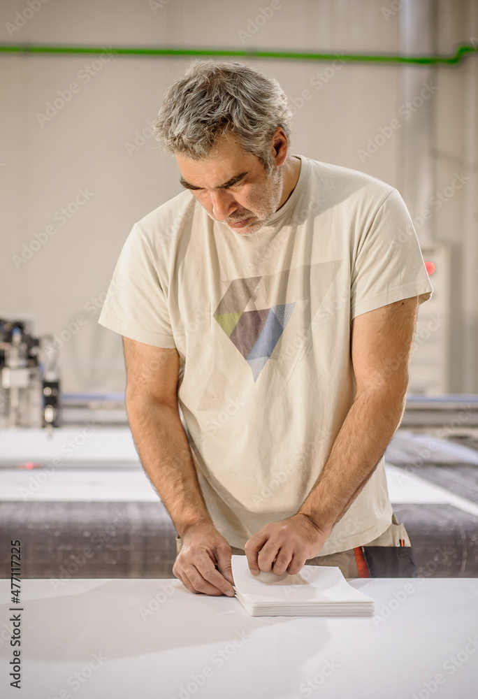 Logistic printing technician worker controls and arranges the printed material Logistic printing technician worker controls and arranges the printed material