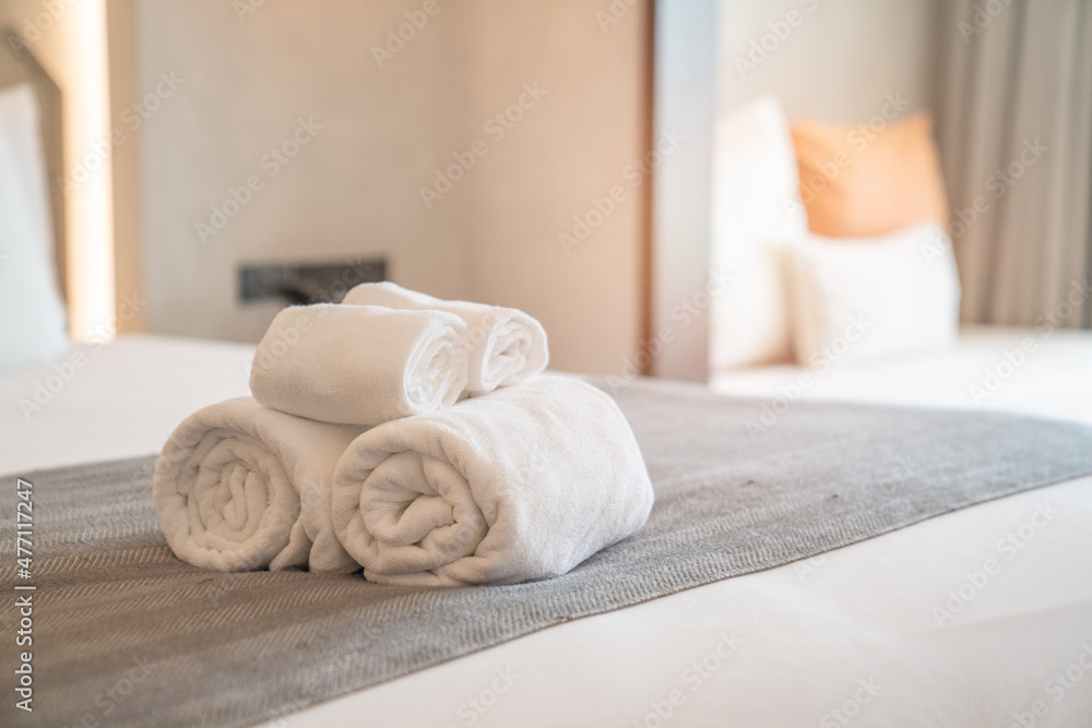 White towels on bed decoration in stylish bedroom interior White towels on bed decoration in stylish bedroom interior