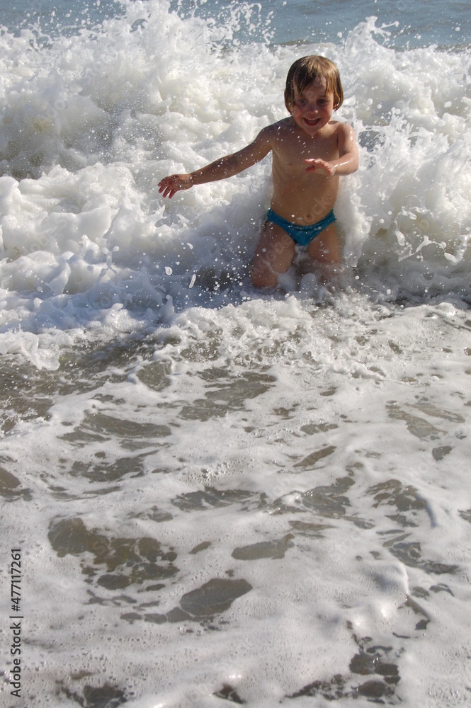 child running in the sea child running in the sea