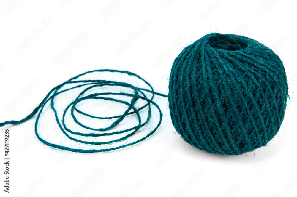 A ball of colored jute twine. Part of the string is unwound and lies nearby A ball of colored jute twine. Part of the string is unwound and lies nearby