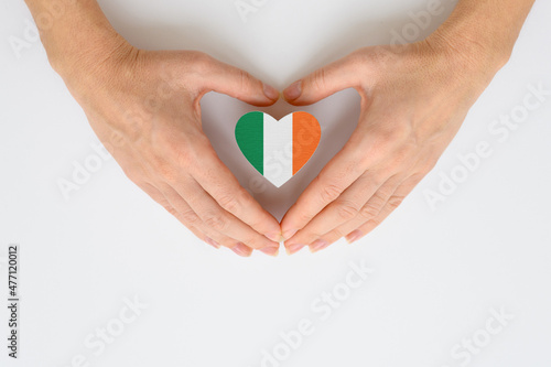 The national flag of Ireland in female hands. The concept of patriotism  respect and solidarity with the citizens of Ireland.