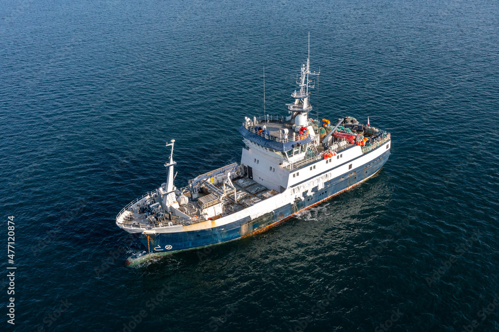 The fishing vessel to the sea.