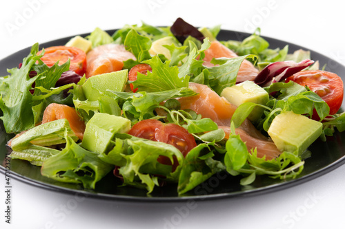 Salmon and avocado salad isolated on white background. Close up