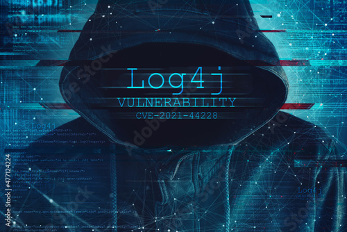 Hooded computer hacker in cybersecurity vulnerability Log4J concept