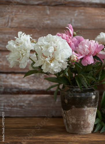 Wallpaper Mural Still life with white and pink peonies in a old ceramic vase on wooden background Torontodigital.ca