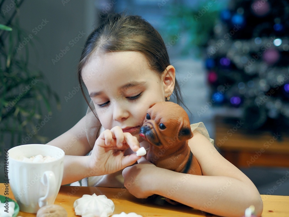 Little girl drinks hot chocolate with marshmallows during the winter holidays, Christmas and New Year. Little girl drinks hot chocolate with marshmallows during the winter holidays, Christmas and New Year.