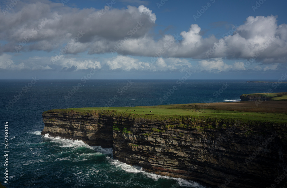 Blue sky with clouds above The cliffs of Downpatrick Head In Ierland