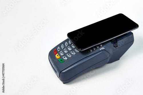 Payment terminal and phone on white background