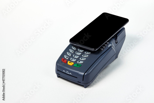 Payment terminal and phone on white background