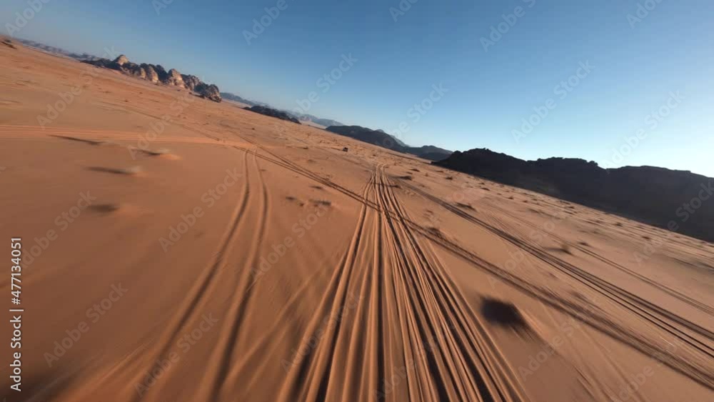 FPV chasing a 4x4 with tourists during the sunrise in the desert of Wadi Rum, Jordan FPV chasing a 4x4 with tourists during the sunrise in the desert of Wadi Rum, Jordan