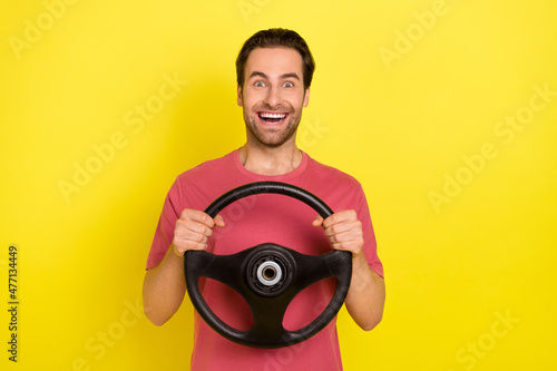 Photo of brunet young hooray guy drive car wear red t-shirt isolated on yellow color background
