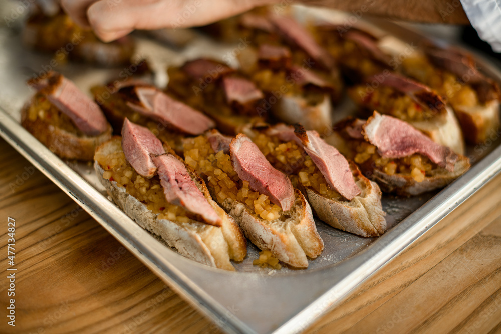 selective focus of appetizer - slices of white baguette with blend vegetable and slices of meat selective focus of appetizer - slices of white baguette with blend vegetable and slices of meat